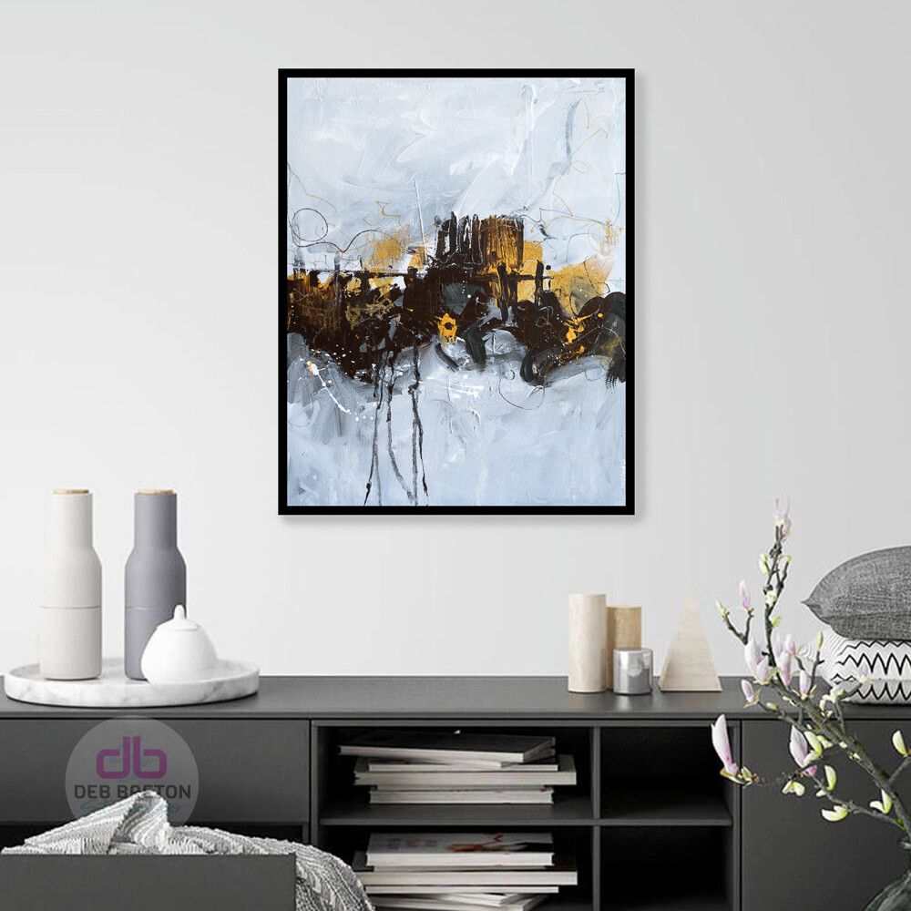 Black and gold abstract painting hanging in living area