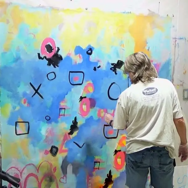 Painter Deb Breton working on extra large abstract painting